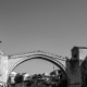 Historic Stari Most bridge in Mostar, Bosnia and Herzegovina, spanning the Neretva River with stone towers and traditional ar